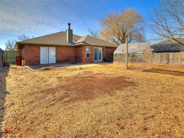 back of house with an outdoor structure