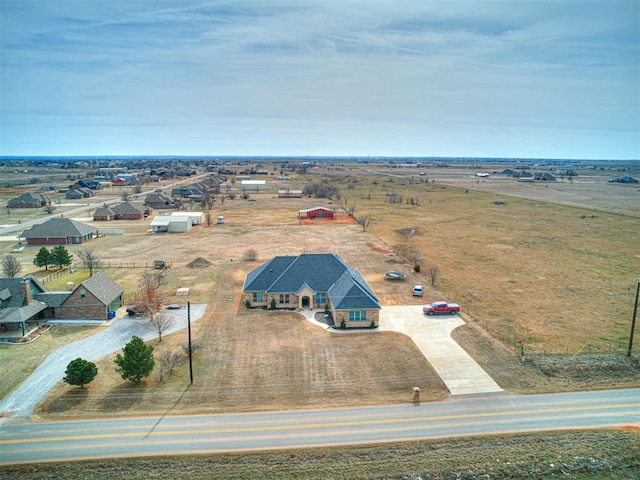 birds eye view of property with a rural view