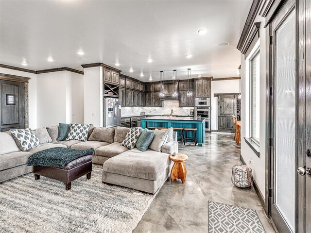 912 Ash NE, Piedmont, OK 73078 - living room with finished concrete flooring, baseboards, crown molding, and recessed lighting