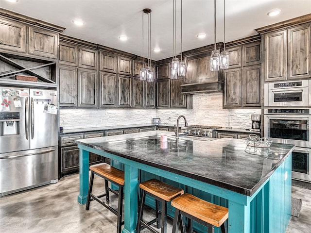 912 Ash NE, Piedmont, OK 73078 - kitchen with stainless steel appliances, dark brown cabinetry, and a spacious island