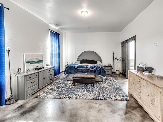 912 Ash NE, Piedmont, OK 73078 - bedroom with a barn door and concrete floors