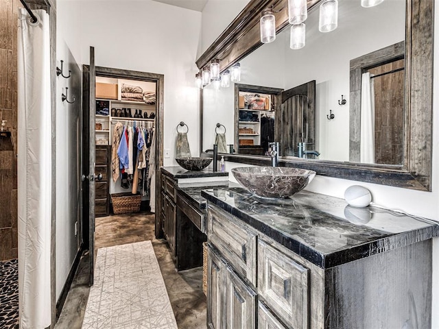 912 Ash NE, Piedmont, OK 73078 - full bathroom with a walk in closet and vanity
