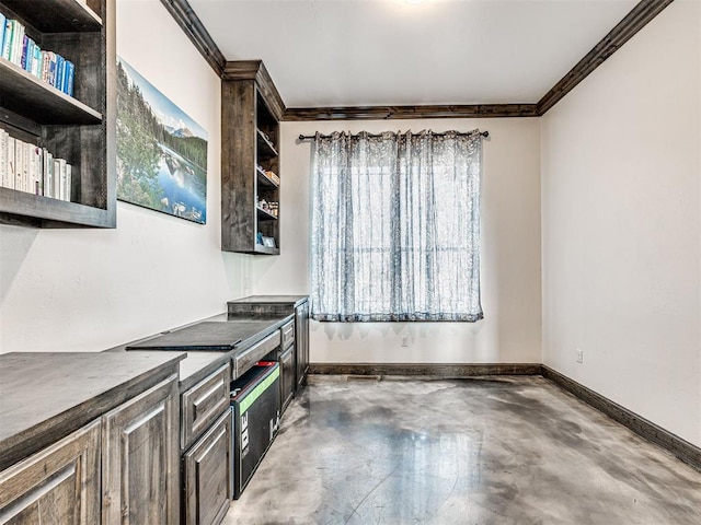 912 Ash NE, Piedmont, OK 73078 - kitchen featuring concrete flooring, baseboards, open shelves, and crown molding