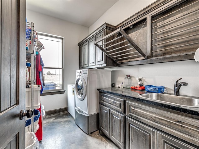912 Ash NE, Piedmont, OK 73078 - clothes washing area with separate washer and dryer, a sink, cabinet space, and baseboards