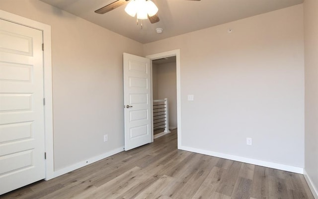 unfurnished room featuring ceiling fan and light wood-type flooring