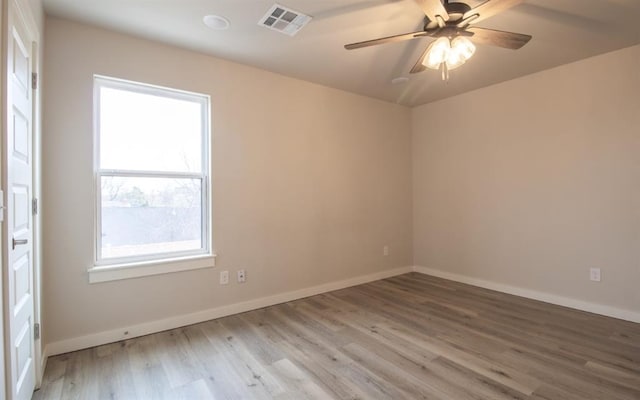 spare room featuring hardwood / wood-style flooring and ceiling fan