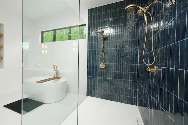 full bathroom featuring a soaking tub and walk in shower