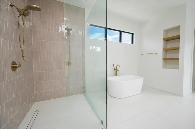 full bath featuring walk in shower and a freestanding bath