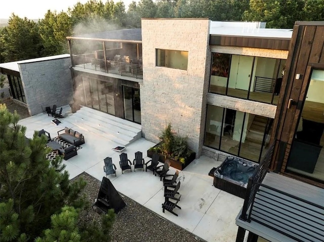 back of property with a patio and a balcony