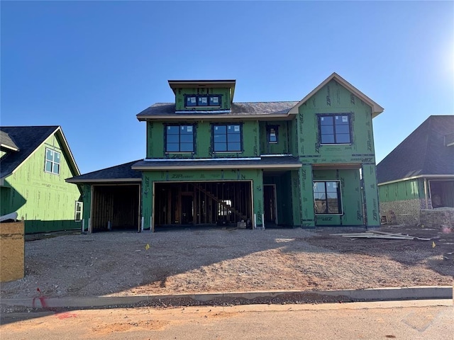 property in mid-construction with driveway and an attached garage