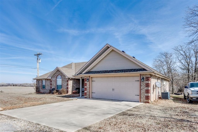 view of front of home featuring central AC unit and a garage