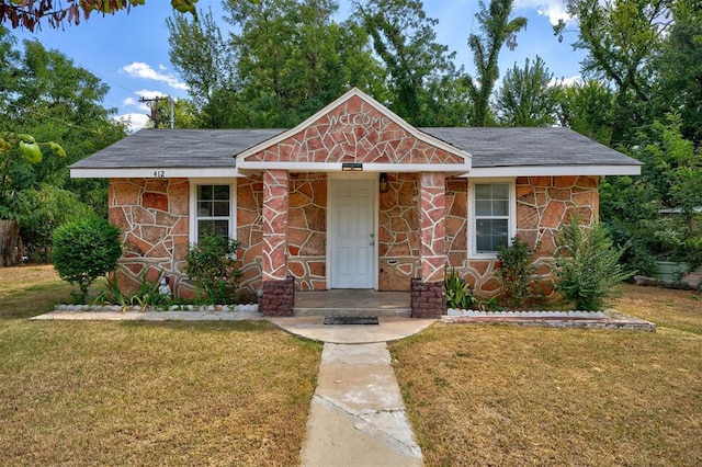 view of front of property featuring stone siding and a front lawn