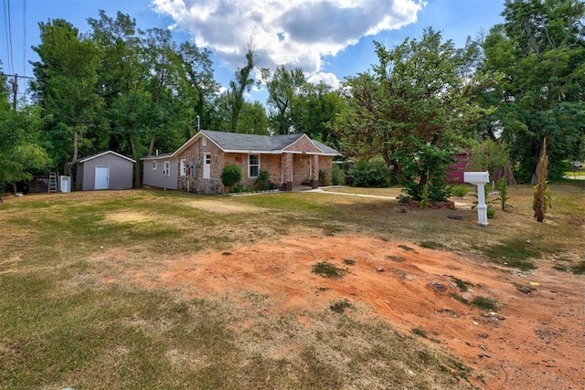 ranch-style home with stone siding, a shed, a front lawn, and an outbuilding