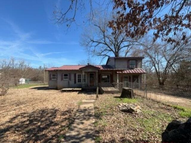 rear view of house with covered porch