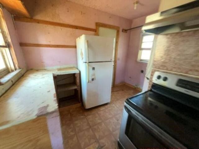 kitchen with stainless steel electric range and white refrigerator