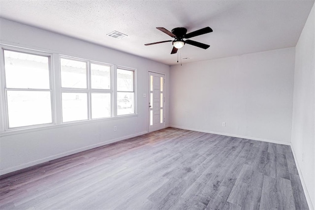 3805 SE 26th St, Del City, OK 73115 - unfurnished room featuring a ceiling fan, wood finished floors, and a textured ceiling