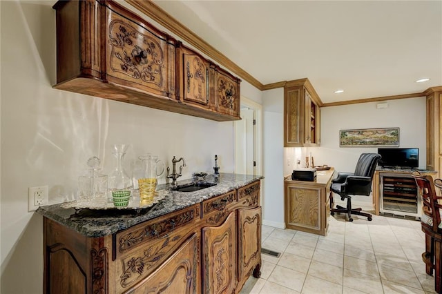 kitchen featuring dark stone counters, wine cooler, glass insert cabinets, crown molding, and a sink