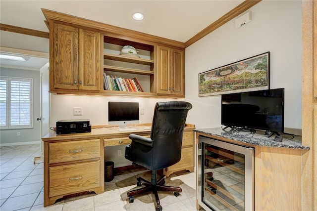 office area with baseboards, built in study area, wine cooler, crown molding, and light tile patterned flooring