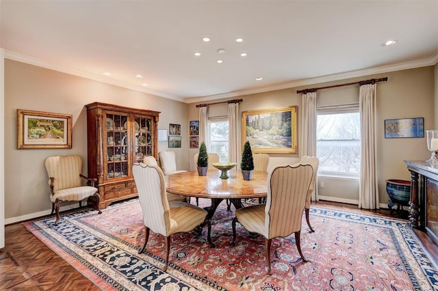 dining room with recessed lighting, a healthy amount of sunlight, crown molding, and baseboards