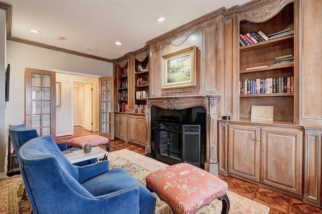 living room with recessed lighting, a fireplace, built in features, and crown molding