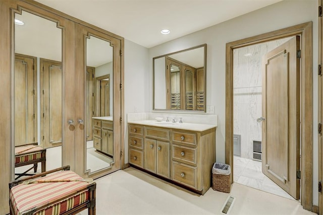 bathroom with vanity, visible vents, and recessed lighting