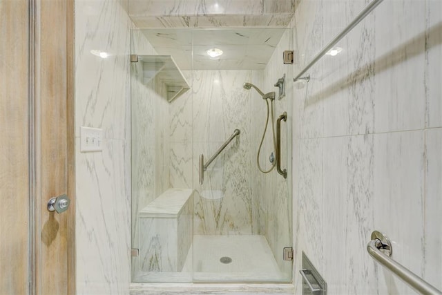 full bathroom with a marble finish shower