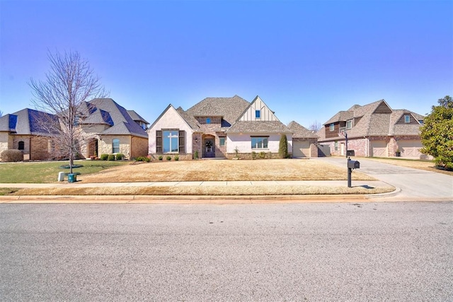 view of front of home featuring a front yard, stone siding, and driveway