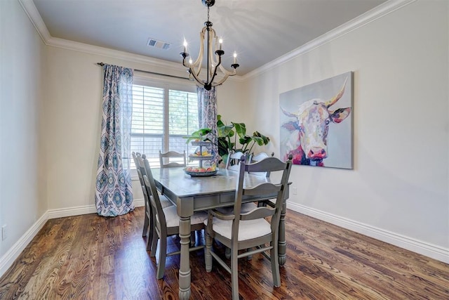 dining space with ornamental molding, visible vents, baseboards, and wood finished floors