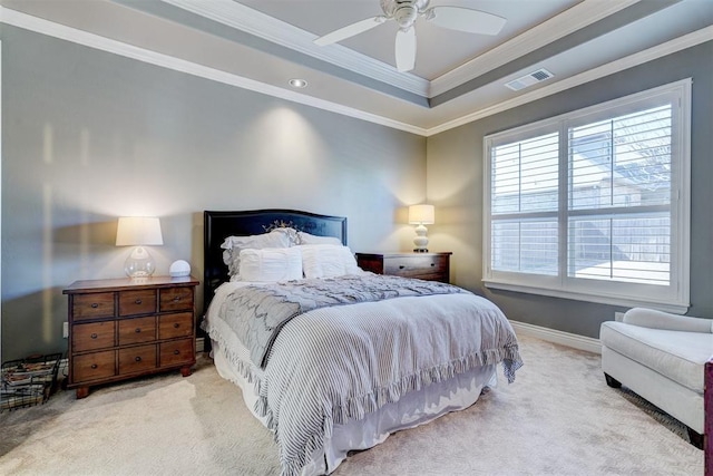 carpeted bedroom featuring a ceiling fan, baseboards, visible vents, a raised ceiling, and crown molding