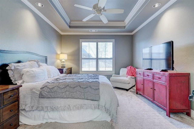 bedroom featuring a raised ceiling, light colored carpet, visible vents, ornamental molding, and ceiling fan