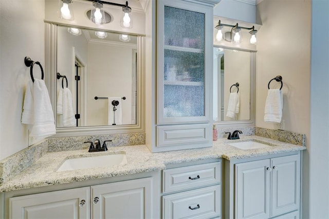 bathroom with crown molding, a sink, and double vanity