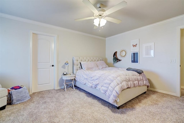 carpeted bedroom featuring ceiling fan, baseboards, and crown molding