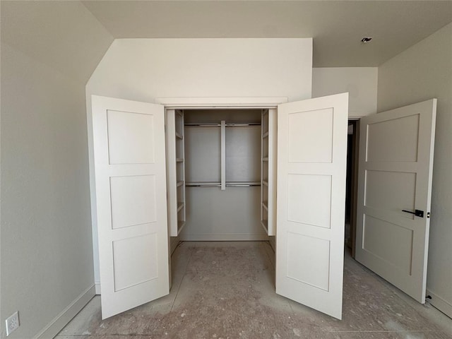 unfurnished bedroom with a closet and baseboards