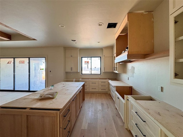 kitchen featuring a center island, light wood finished floors, and recessed lighting