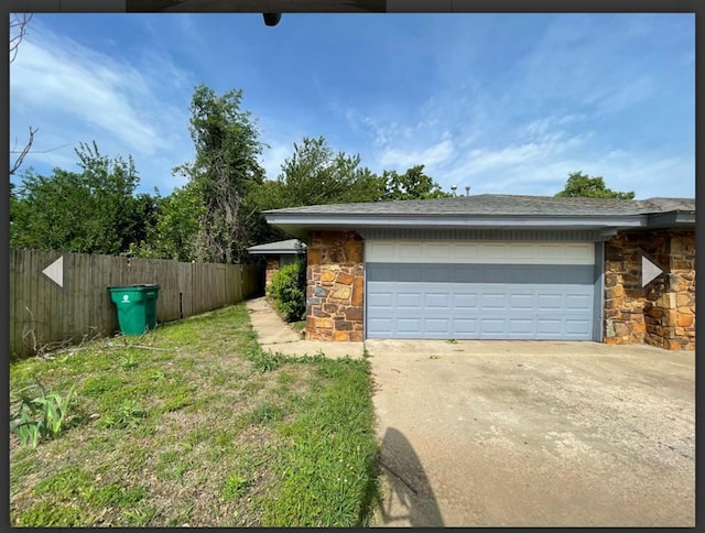 exterior space featuring driveway and fence