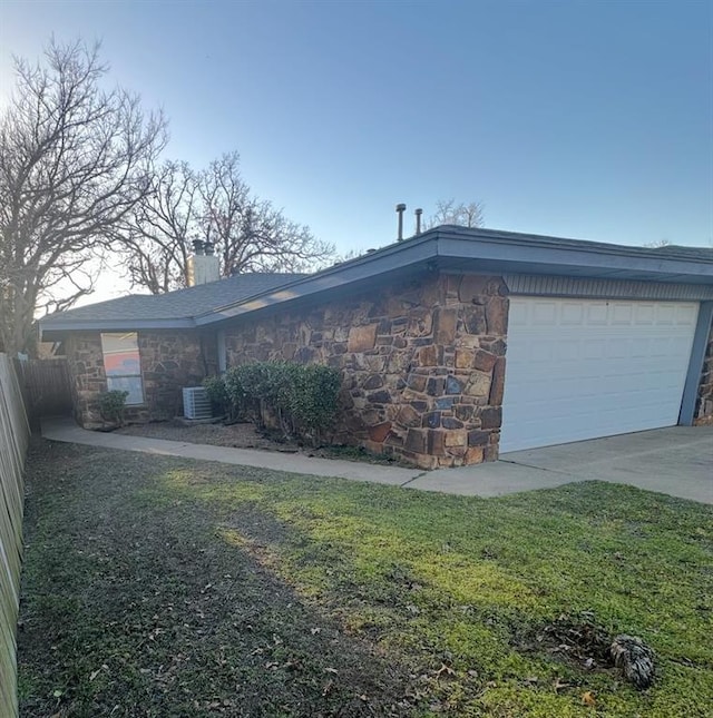 view of property exterior featuring fence, central AC unit, a chimney, stone siding, and driveway