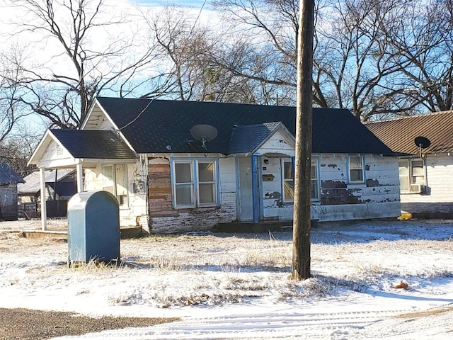 view of front of house featuring stone siding and an attached carport