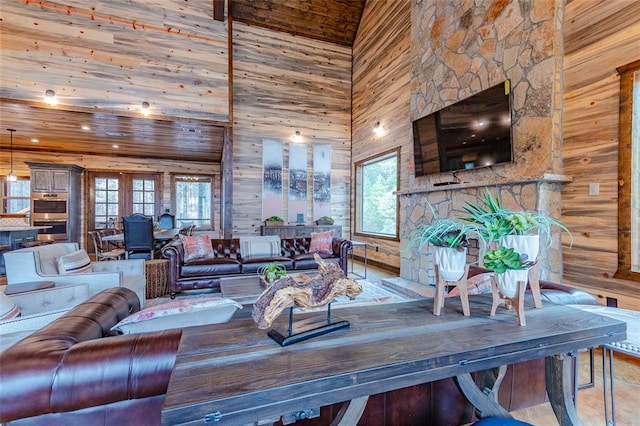 living room featuring a towering ceiling, wood ceiling, and a fireplace