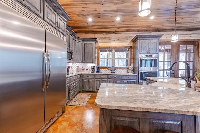 kitchen featuring light stone counters, stainless steel appliances, hanging light fixtures, wood ceiling, and a sink