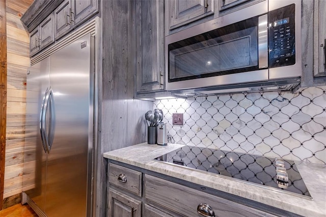 kitchen with stainless steel appliances, tasteful backsplash, light countertops, mail area, and dark brown cabinetry