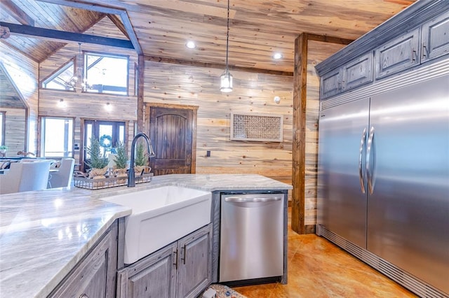 kitchen featuring wooden ceiling, appliances with stainless steel finishes, light stone counters, hanging light fixtures, and a sink