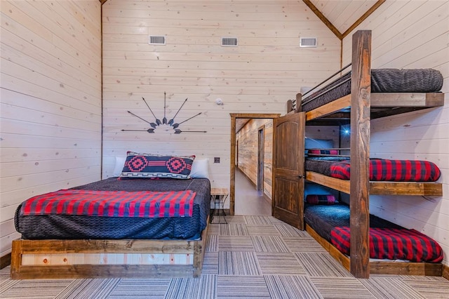 bedroom with visible vents and wooden walls