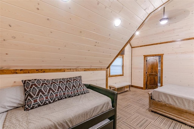 carpeted bedroom featuring lofted ceiling, wood walls, and wooden ceiling