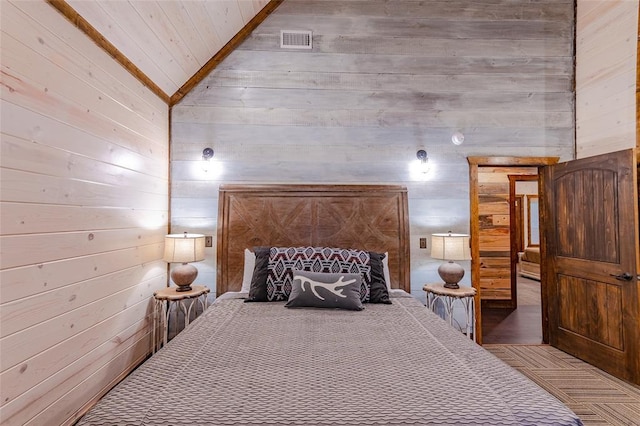 bedroom featuring high vaulted ceiling, visible vents, and wood walls