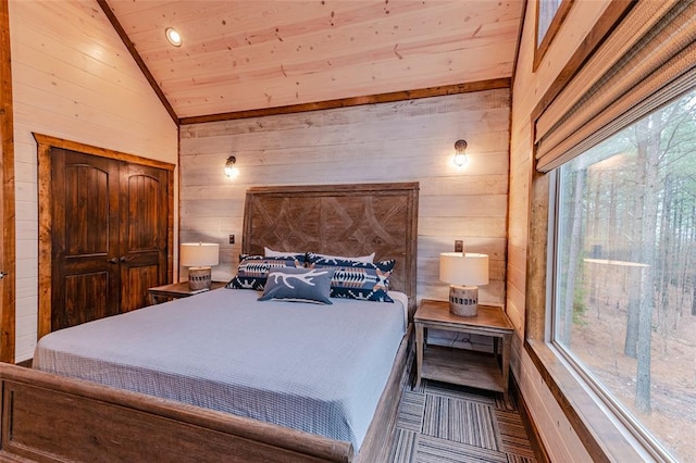 bedroom with wood ceiling, multiple windows, vaulted ceiling, and wooden walls