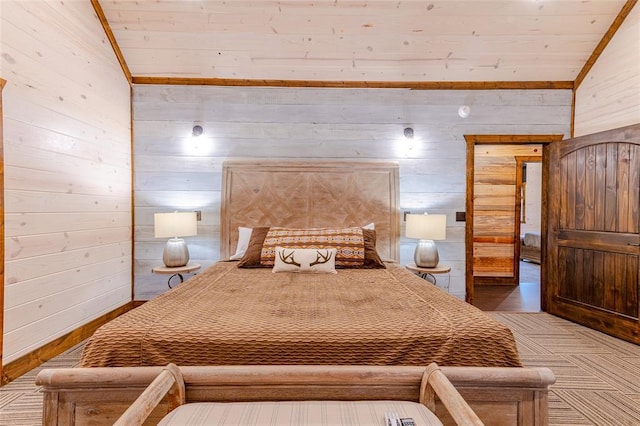 bedroom featuring vaulted ceiling, light colored carpet, and wooden walls