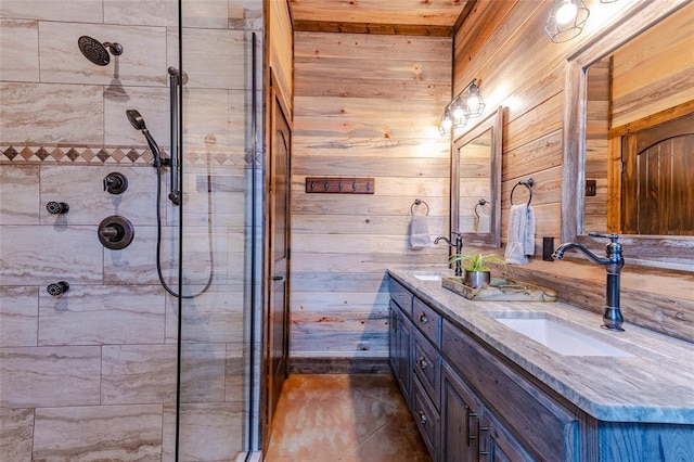 bathroom with tiled shower, a sink, wood walls, and double vanity