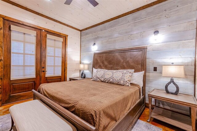 bedroom with wooden walls and french doors