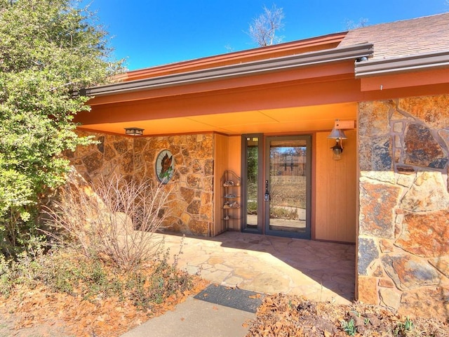 property entrance with stone siding