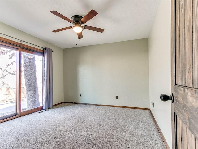 carpeted empty room featuring a textured ceiling, ceiling fan, visible vents, and baseboards